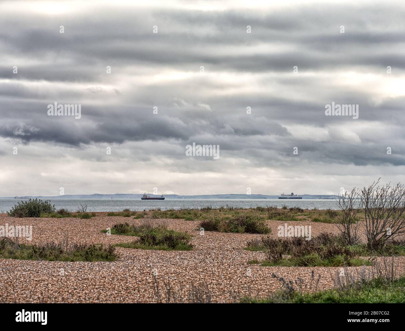 The coast of North West France with the two capes Blanc Nez and Gris Nez seen from the beach at Walmer in Kent with ships in the channel Stock Photo