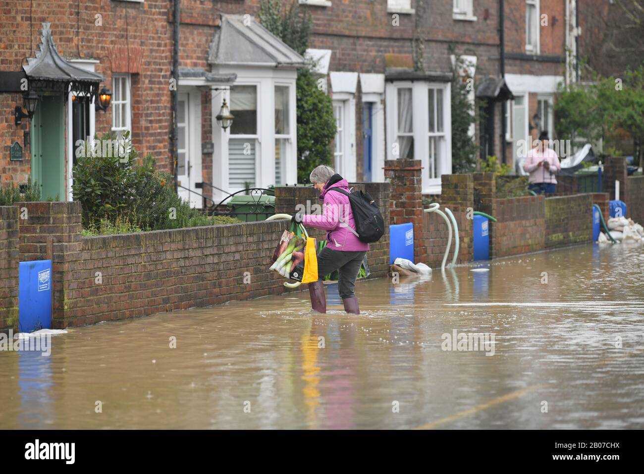 A woman carrying shopping bags through flood water hi-res stock photography  and images - Alamy