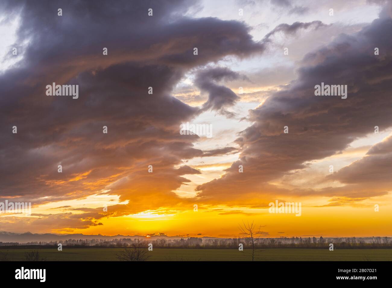 foehn, golden sunset behind the Alps and ground fog, Germany, Bavaria, Griesstaett Stock Photo