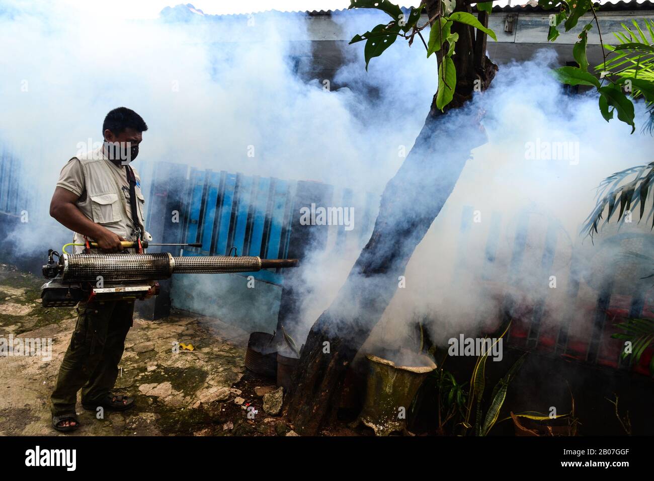 Jakarta, Indonesia - November 5th, 2020: Smoke fogging by to kill dengue Aedes aegypti mosquito or to prevent Zika viruses using blowing machine Stock Photo