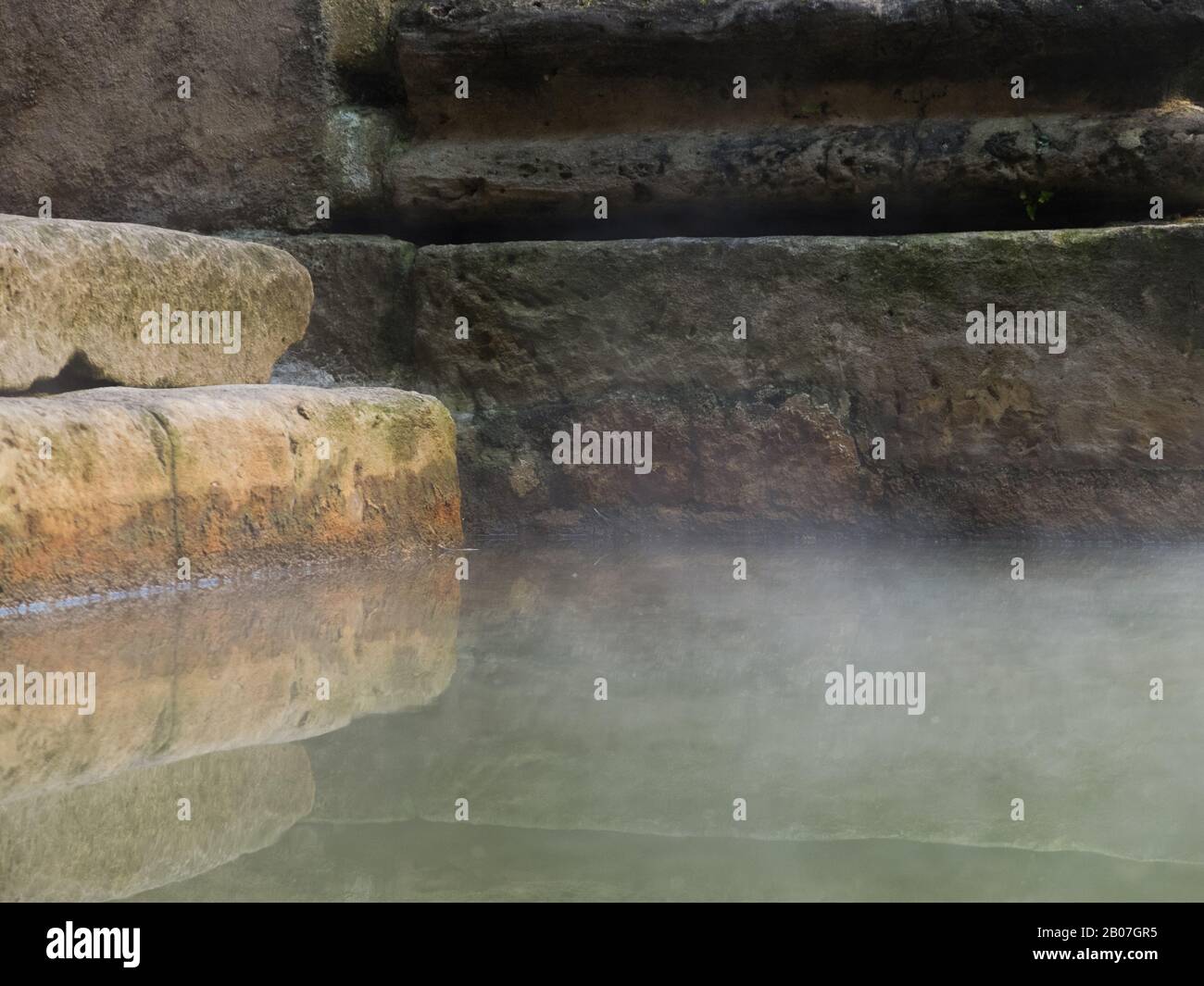 Rising steam floats across the spring water of the Great Bath in the historic Roman Baths, City of Bath, Somerset, UK Stock Photo