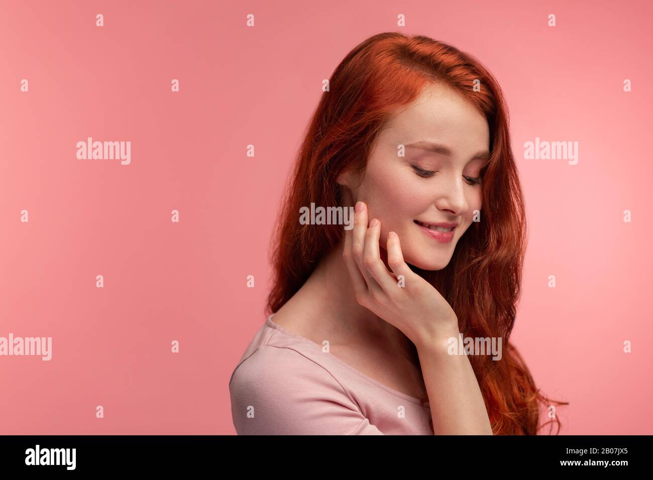 Portrait Of Smiling Redhead Girl Perfect Skin Beautiful Female Model With Long Hair Over Pink
