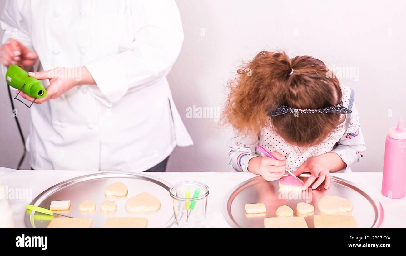 Step by step. Drying royal icing on sugar cookies with small heat gun