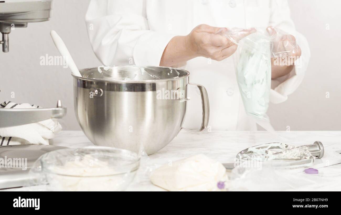 Mixing ingredients in standing kitchen mixer to make buttercream