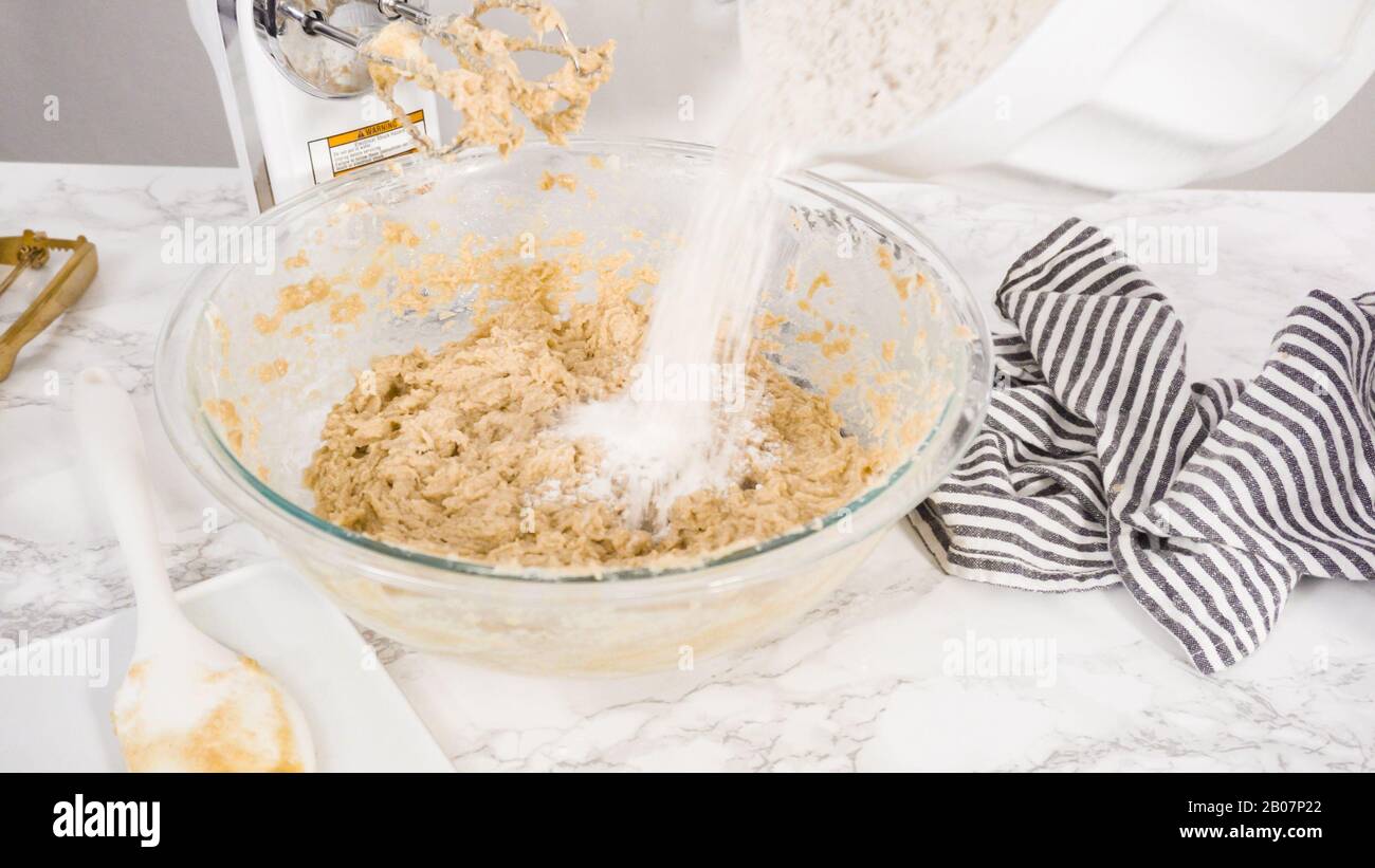 Step by step. Mixing ingredients in a glass bowl to make chocolate chip