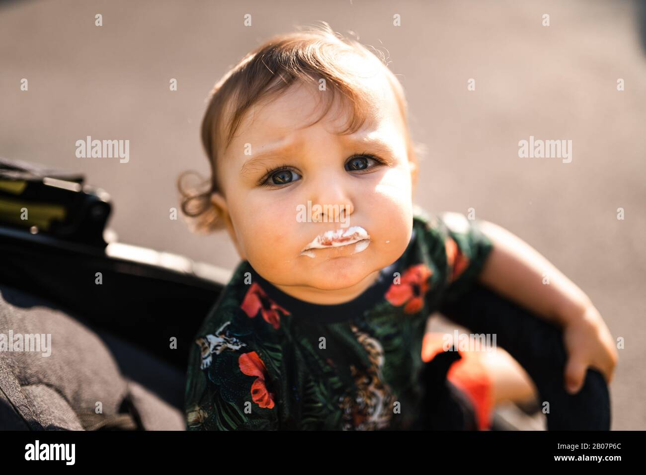 Mother feeding baby child boy icecream Young mom and her baby eat