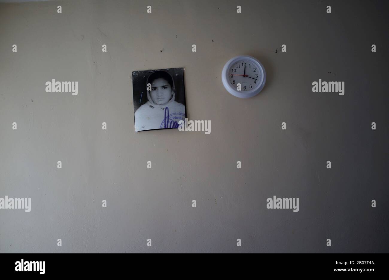 Passport photo and clock on wall Stock Photo