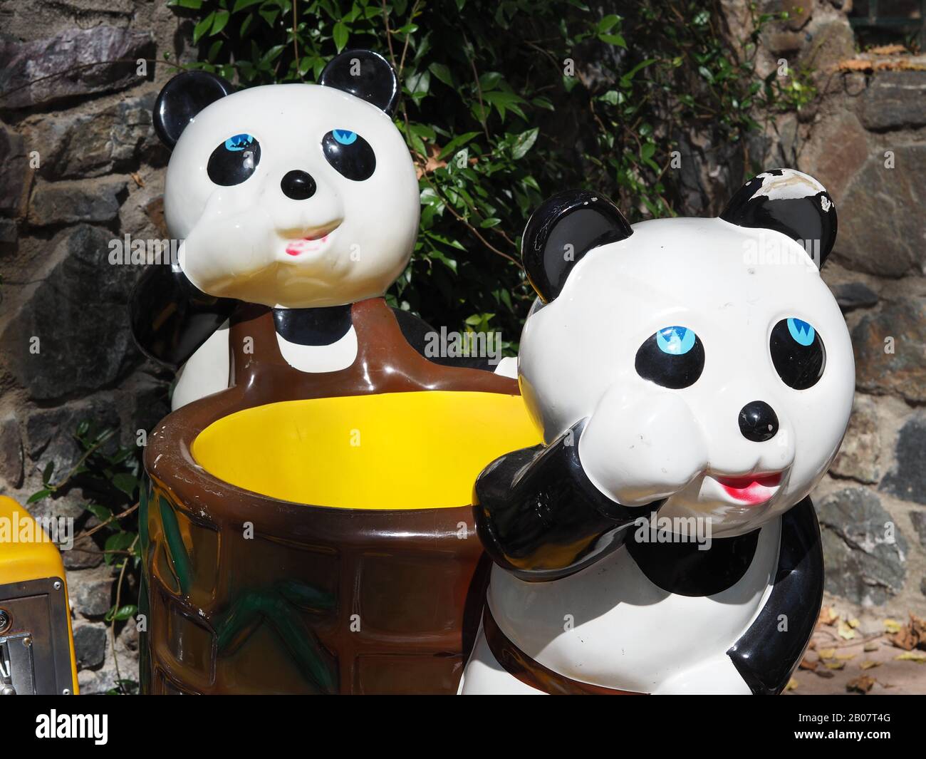 Two pandas on a children's ride in a cafe in Ano Poroia, Central Macedonia, Greece Stock Photo