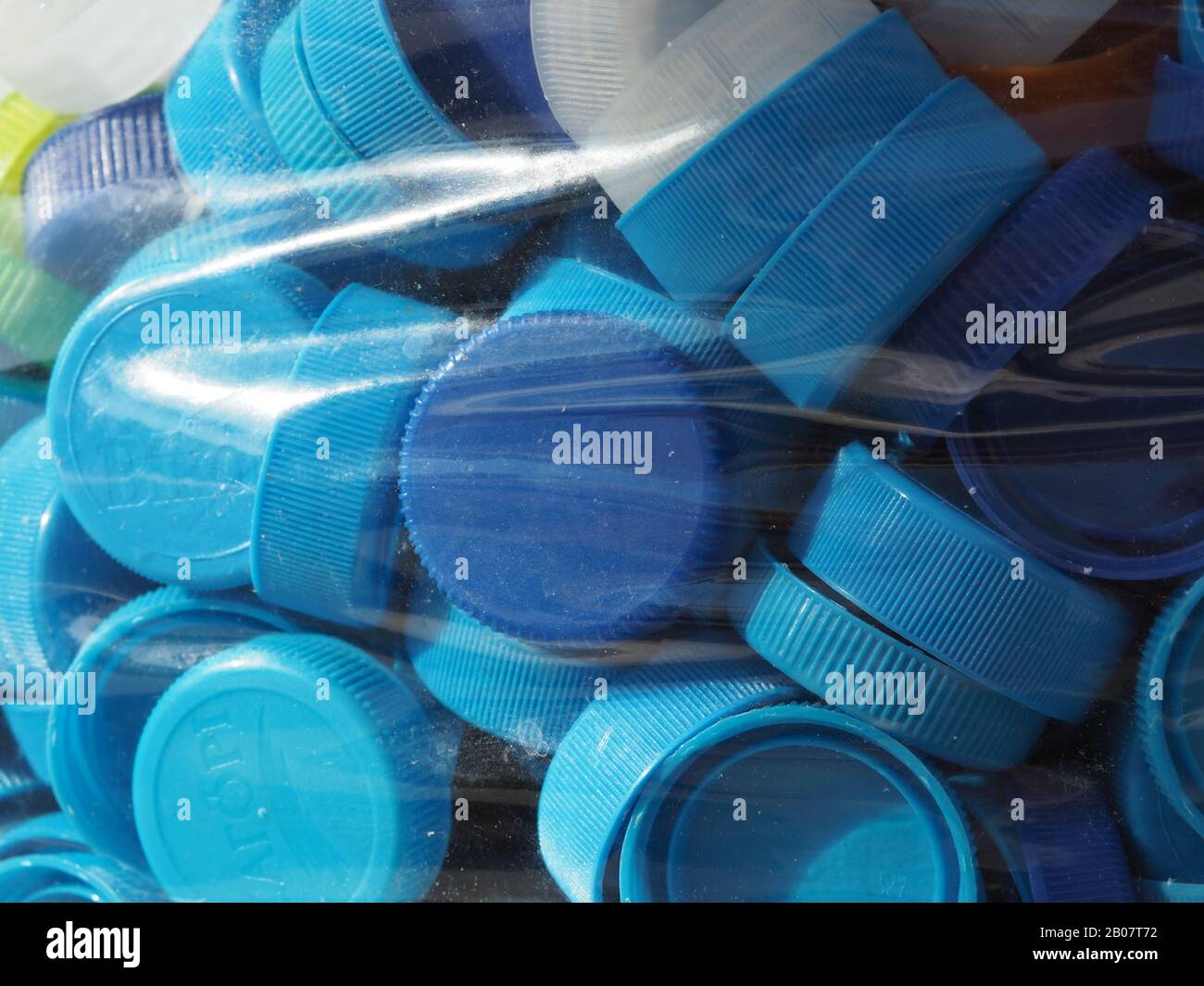 Blue plastic bottle tops wrapped ready for recycling Stock Photo