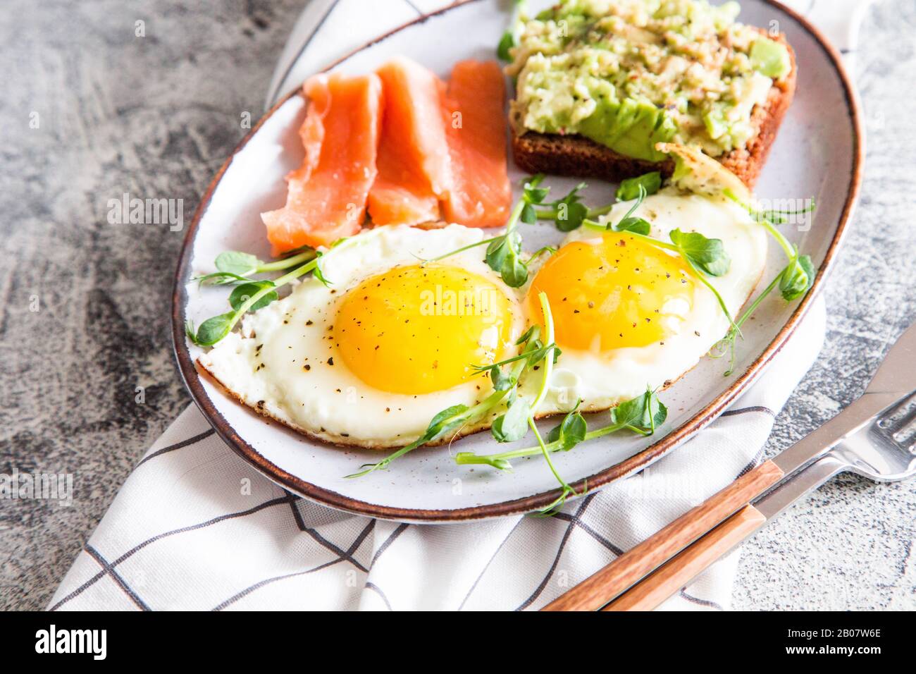 Egg breakfast. Healthy nutritious breakfast with eggs, salmon, avocado