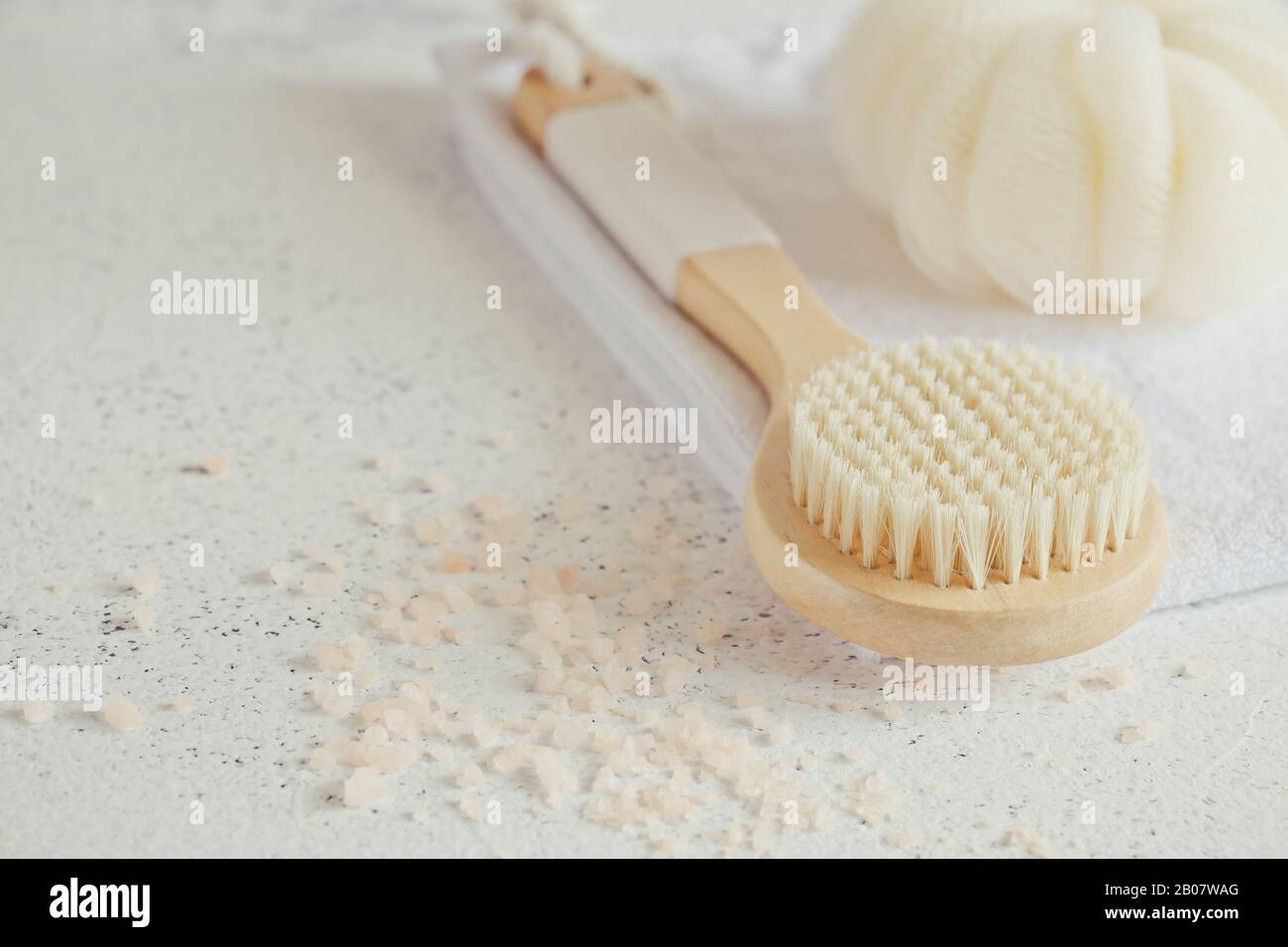 Spa beauty concept. Anti-cellulite massage. Bath Accessories on white stone background, top view, copy space / Stock Photo