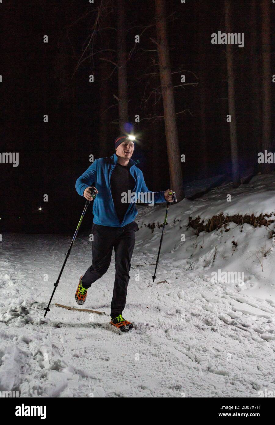 ALMATY KAZAKHSTAN: FEBRUARY 15, 2020: Unidentified people run at winer night in the mountains near the city of Almaty with flashlights during the Stock Photo