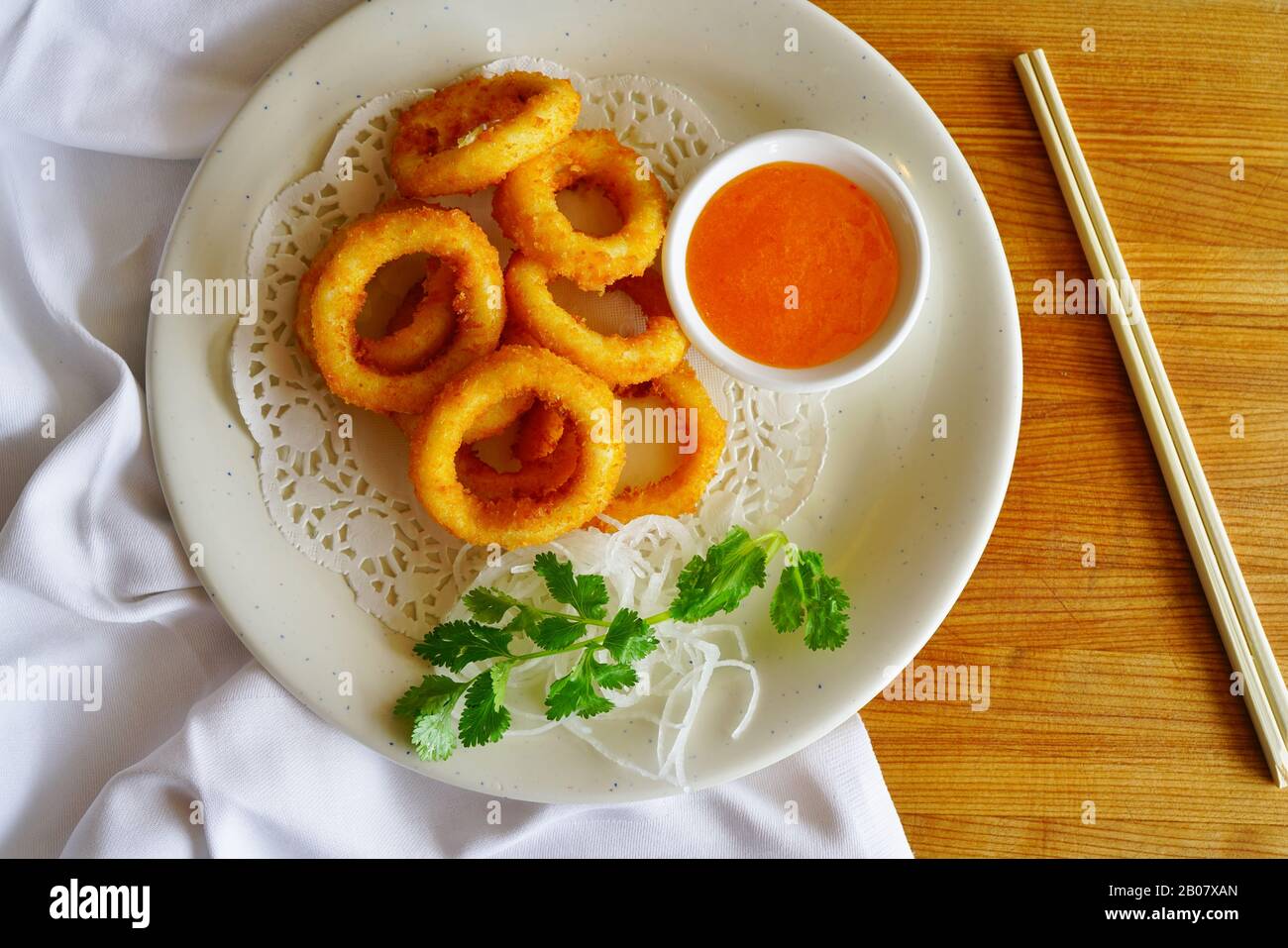 Fried calamari rings with a sweet and sour sauce at a Japanese sushi
