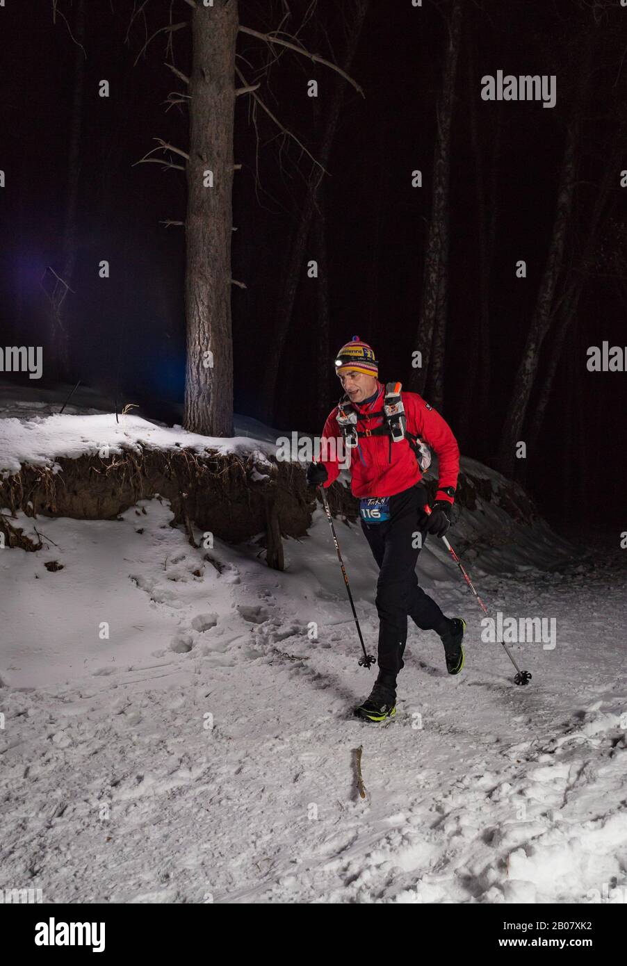ALMATY KAZAKHSTAN: FEBRUARY 15, 2020: Unidentified people run at winer night in the mountains near the city of Almaty with flashlights during the Stock Photo