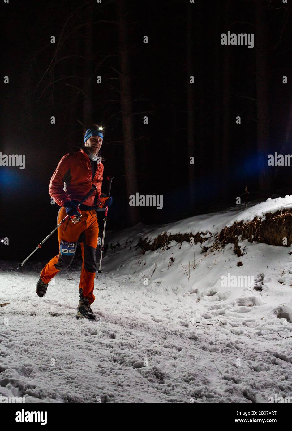 ALMATY KAZAKHSTAN: FEBRUARY 15, 2020: Unidentified people run at winer night in the mountains near the city of Almaty with flashlights during the Stock Photo