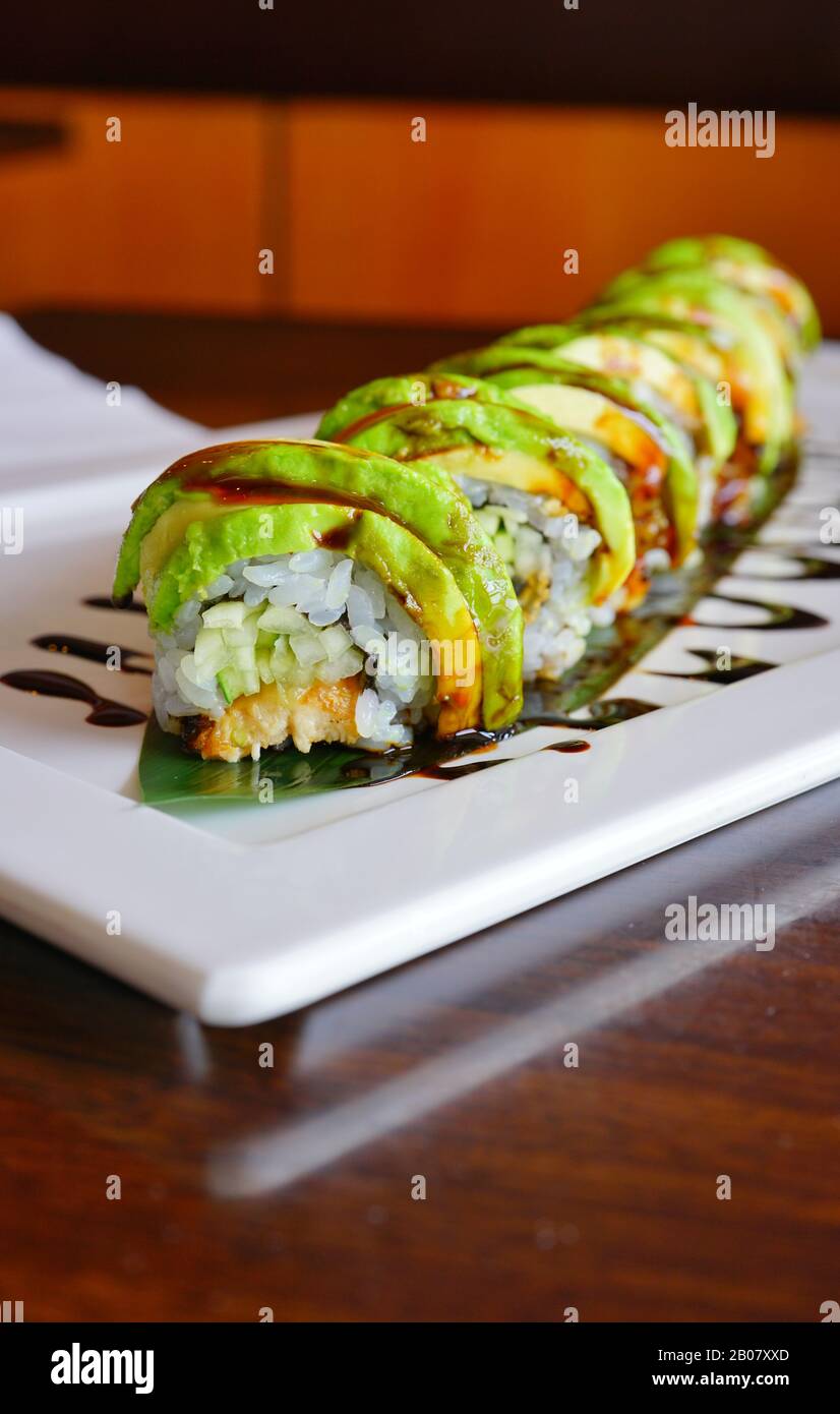 A plate of dragon sushi roll with eel sauce at a Japanese restaurant