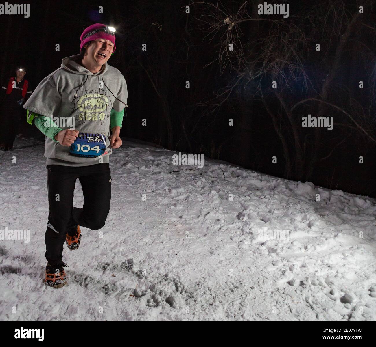 ALMATY KAZAKHSTAN: FEBRUARY 15, 2020: Unidentified people run at winer night in the mountains near the city of Almaty with flashlights during the Stock Photo