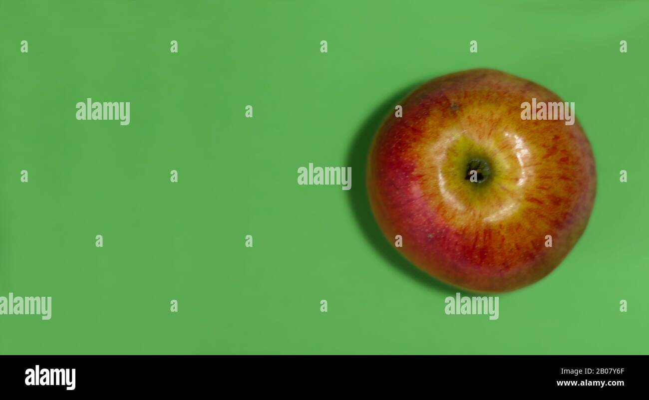 Red Apple Rawa ripe raw red apple on an green background, top view fruit healthy ...