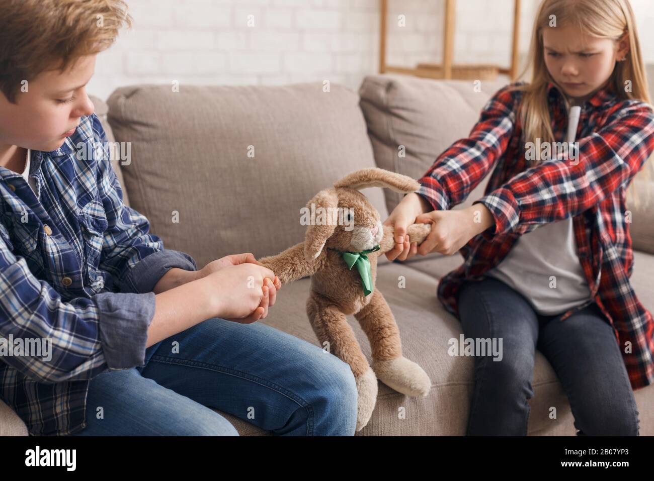 Boy And Girl Not Wanting To Share A Toy Indoor Stock Photo