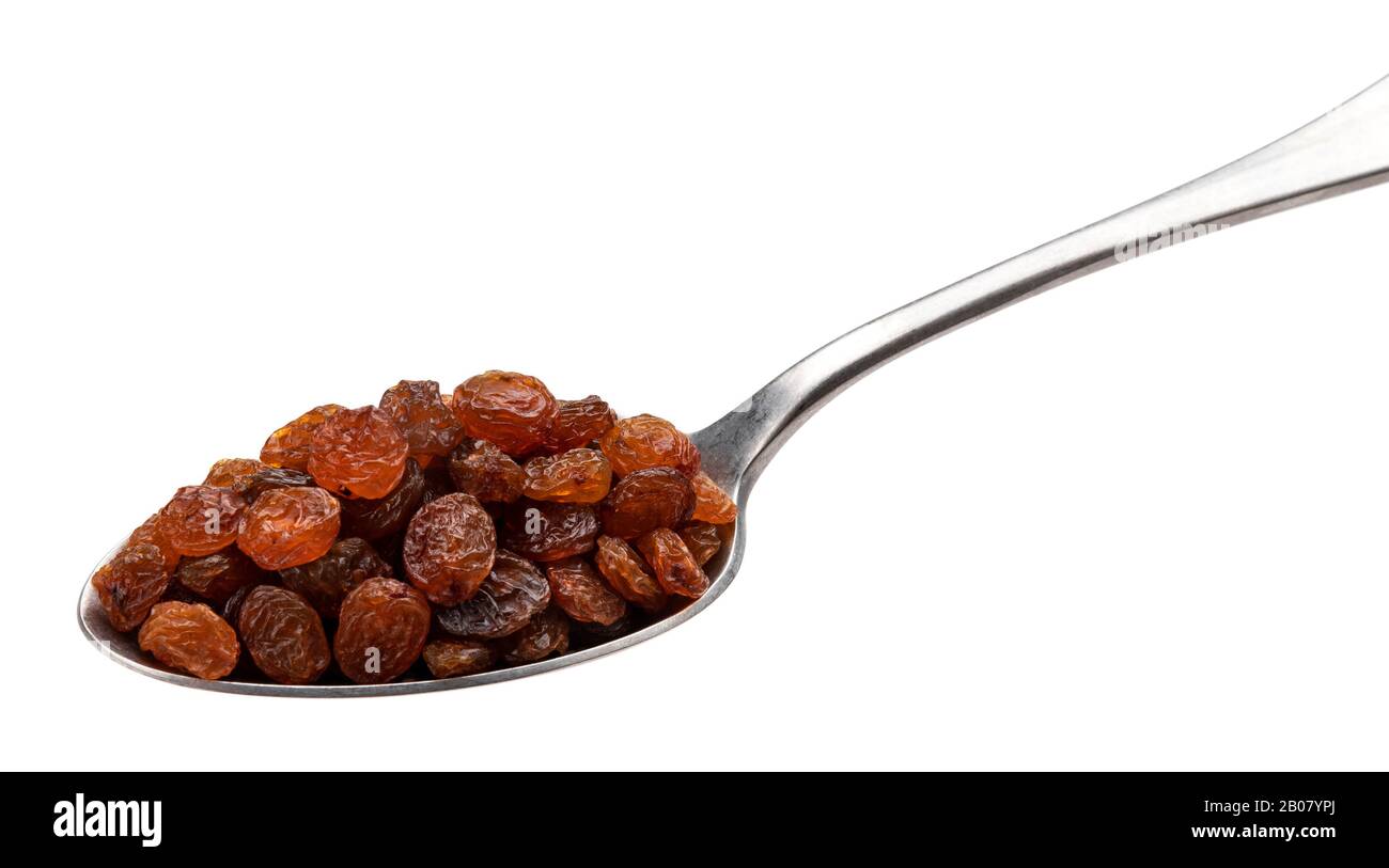 Raisins in spoon isolated on white background Stock Photo