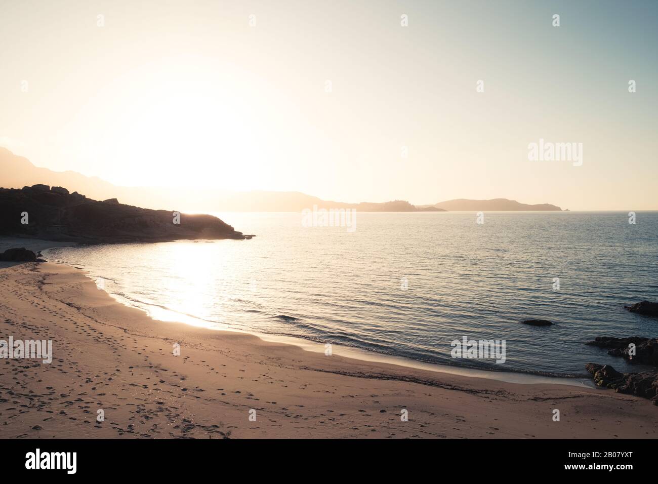 Sun setting over the golden Plage de Sainte Restitude beach in the Balagne region of Corsica