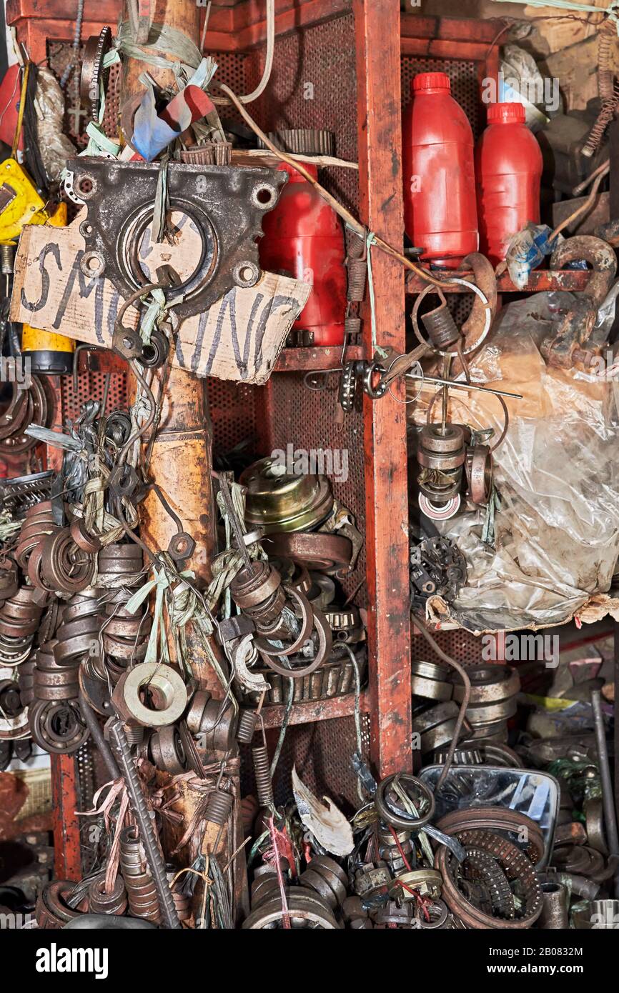 Close-up of a messy pile of old used rusty bearings and other car parts stuffed in cabinets in a auto junk shop in Iloilo City, Philippines, Asia Stock Photo