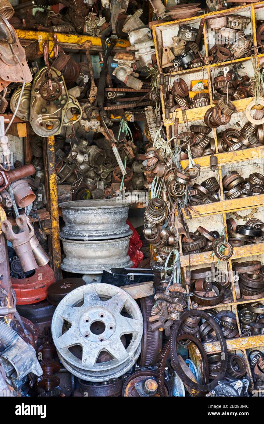 Close-up of a messy pile of old used rusty bearings, wheels and other car parts stuffed in cabinets in a junk shop in Iloilo City, Philippines, Asia Stock Photo