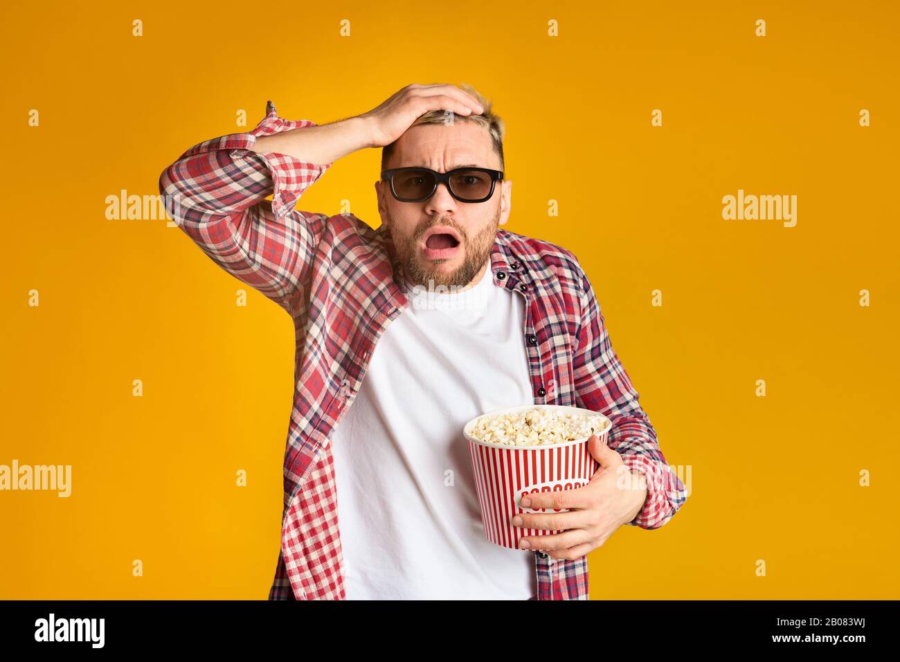 Experiencer Young guy in 3d glasses watching cinema Stock Photo