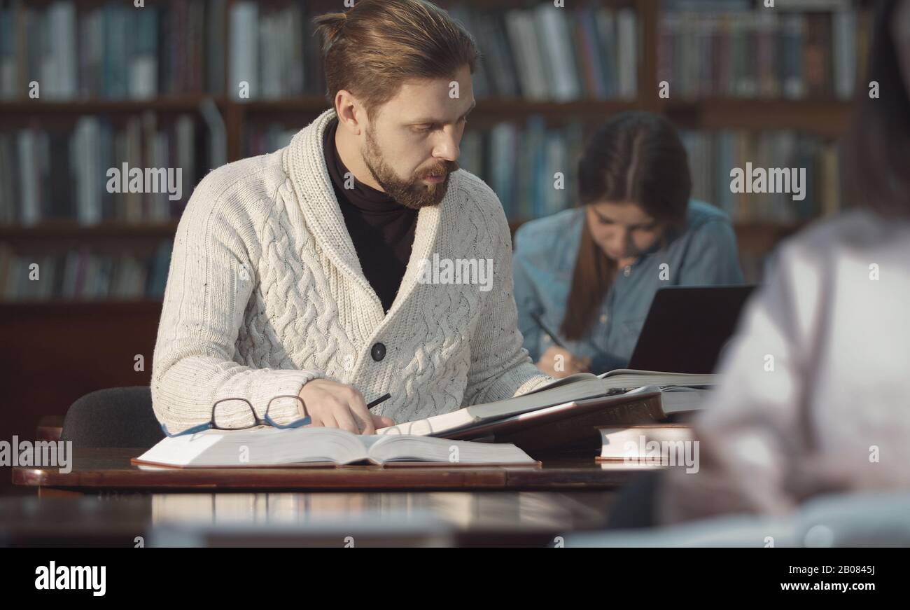 Mature man researching in library Stock Photo