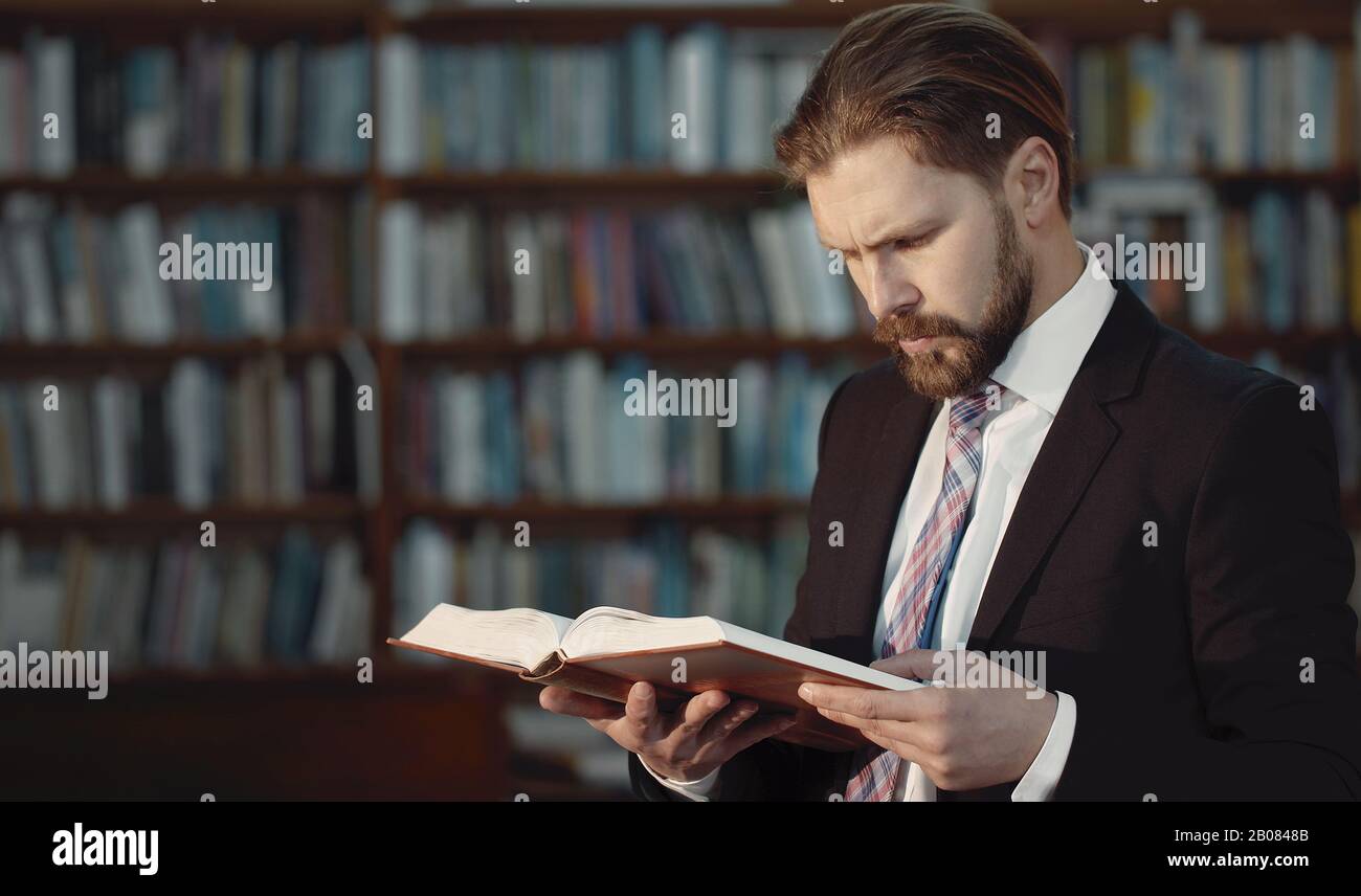 Business-looking man reading book Stock Photo