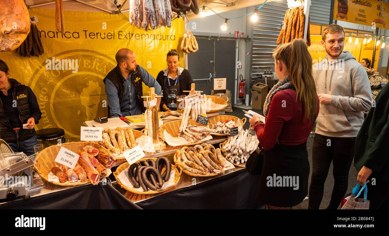 Strasbourg, France - Feb 16, 2020: Visitors people buying meat and sausage products at Independent winemakers of France wine fair for private and horeca customers Stock Photo