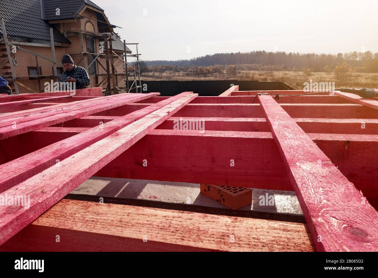 Installation of wooden beams in the construction of the roof system of