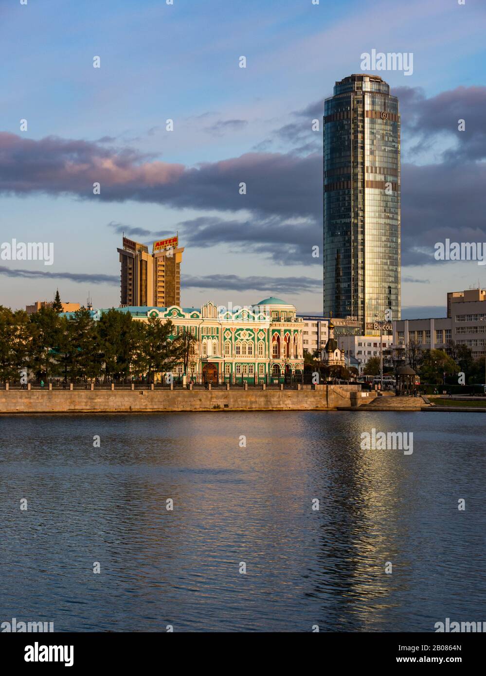 Reflection of Vysotsky Tower at sunset, Gorodskoy Prud or City Pond, Yekaterinburg, Siberia, Russian federation Stock Photo