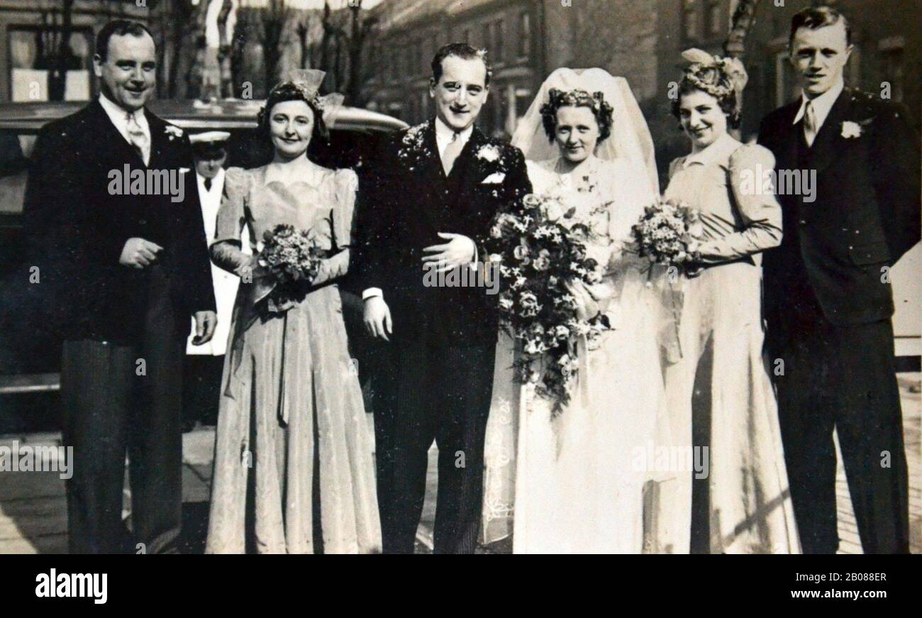 A formal photograph of a wedding group in 1940 in Blackpool, Lancashire, United Kingdom. Ida Gregory marries Sid Waller. On the right, Alfred Gregory, Ida Gregory's brother, later a member of the 1953 British Mount Everest Expedition that made the first ascent of Mount Everest; he was in charge of stills photography. As a climbing member of the team, he reached 28,000 feet (8,500 metres) in support of the successful Hillary-Tenzing assault on the summit. Later, for 20 years, he worked freelance for Kodak UK, lecturing on photography. Stock Photo