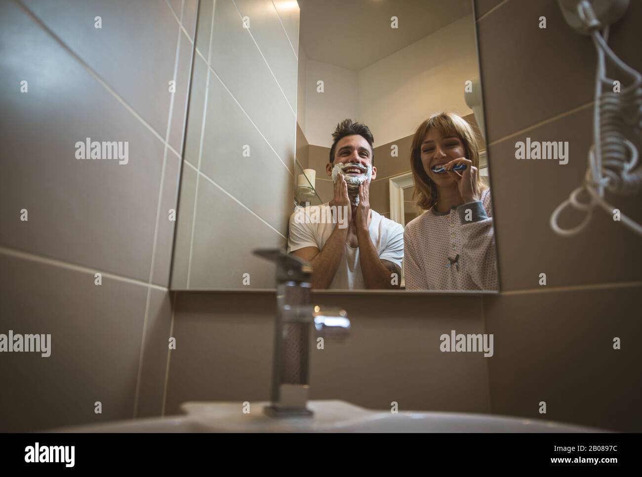 Couple Morning Routine Man And Woman Sharing Bathroom Shaving Beard And Brushing Teeth Stock