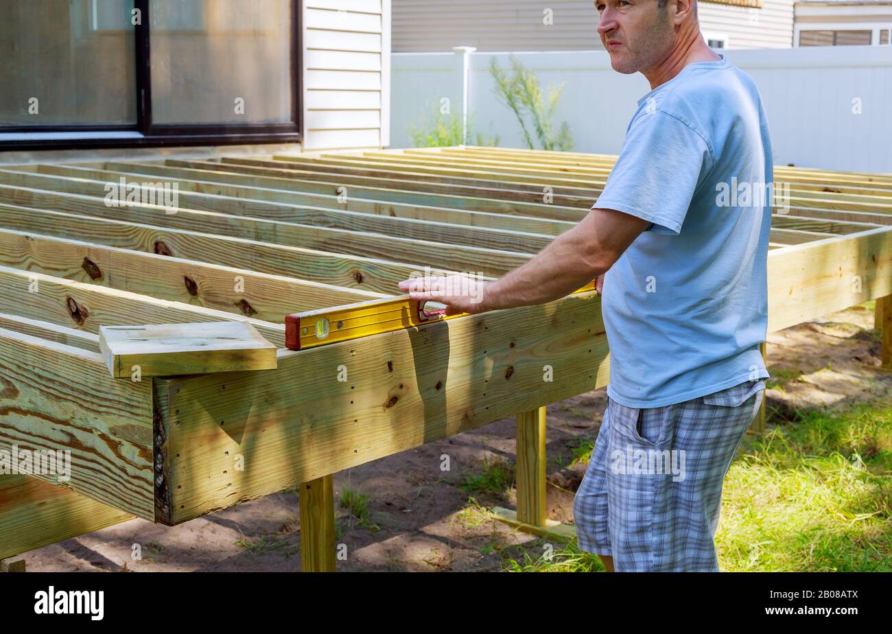 Installing wood floor for patio deck with new wooden decking fragment planks Stock Photo Alamy