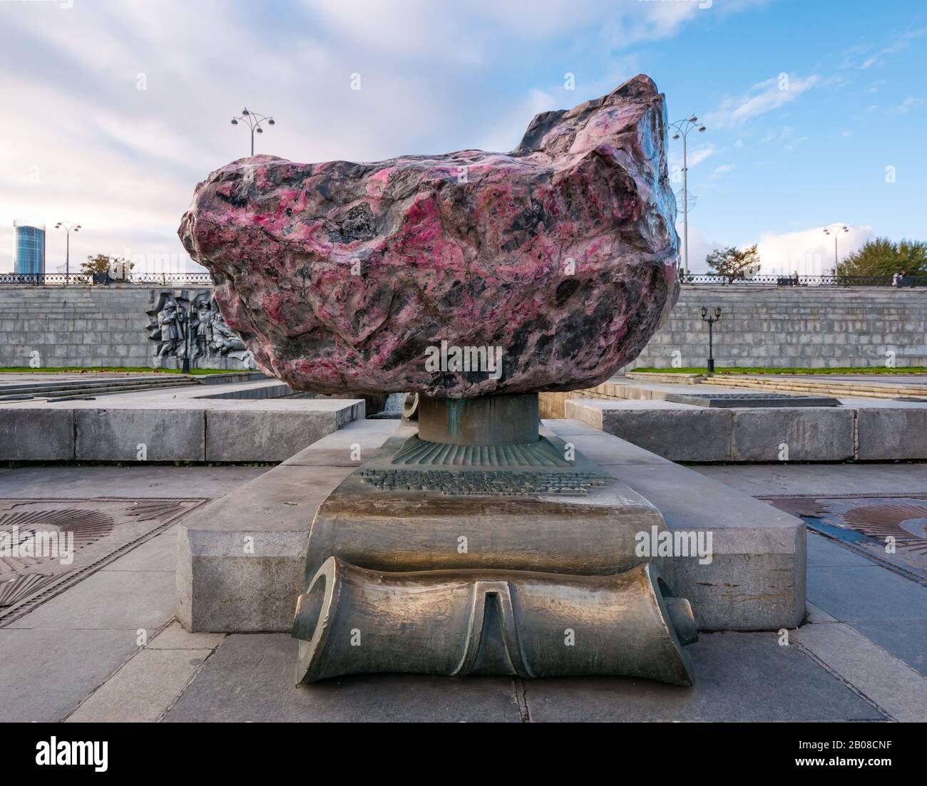 Love Stone, large pink rhodonite boulder, Iset River dam weir, Plotinka park, Yekaterinburg, Siberia, Russian federation Stock Photo