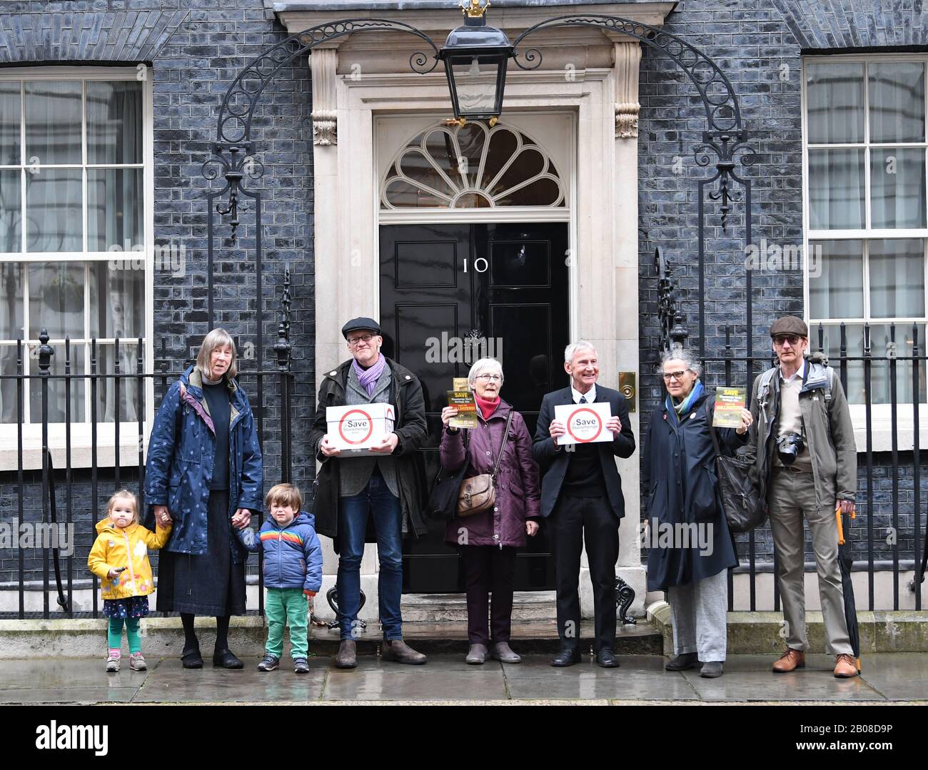Author and historian Tom Holland (second left) stands outside 10 Downing  Street, London, as he holds a box containing a petition with 50,000  signatures calling for 'no further damage' to the Stonehenge