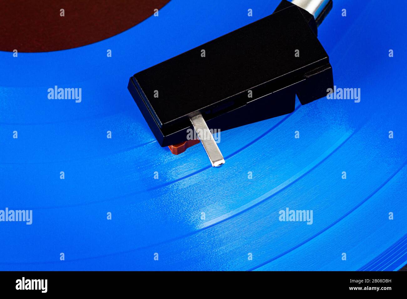 Close up of turntable cartridge on a vinyl record. Turntable playing vinyl. Needle on rotating