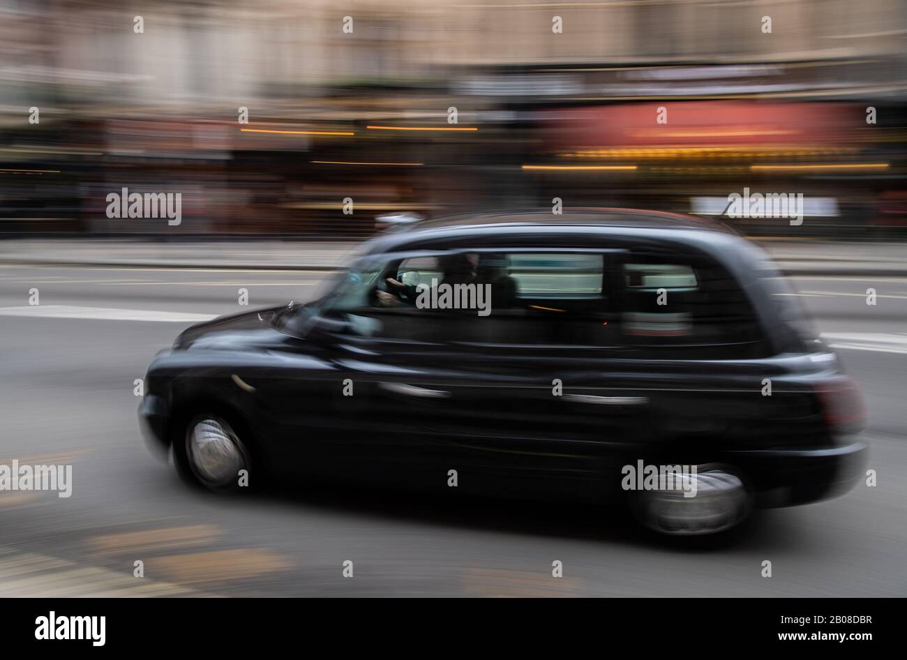 19 February 2020, Great Britain, London: A Black Cab (taxi) drives over Whitehall in central London (shot with a long shutter speed). Photo: Robert Michael/dpa-Zentralbild/dpa Stock Photo