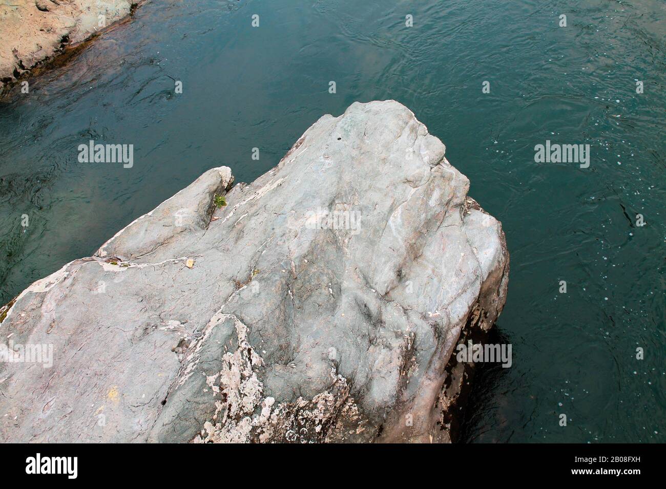 Rock in the mountain flowing green river Stock Photo Alamy