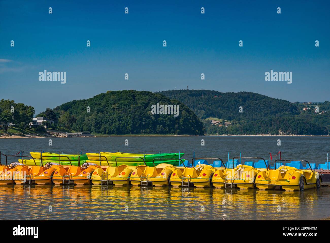 Paddle boats at pier on Roznowskie Lake, reservoir on Dunajec river, Roznow Foothills, Western Carpathians, Malopolska, Poland Stock Photo