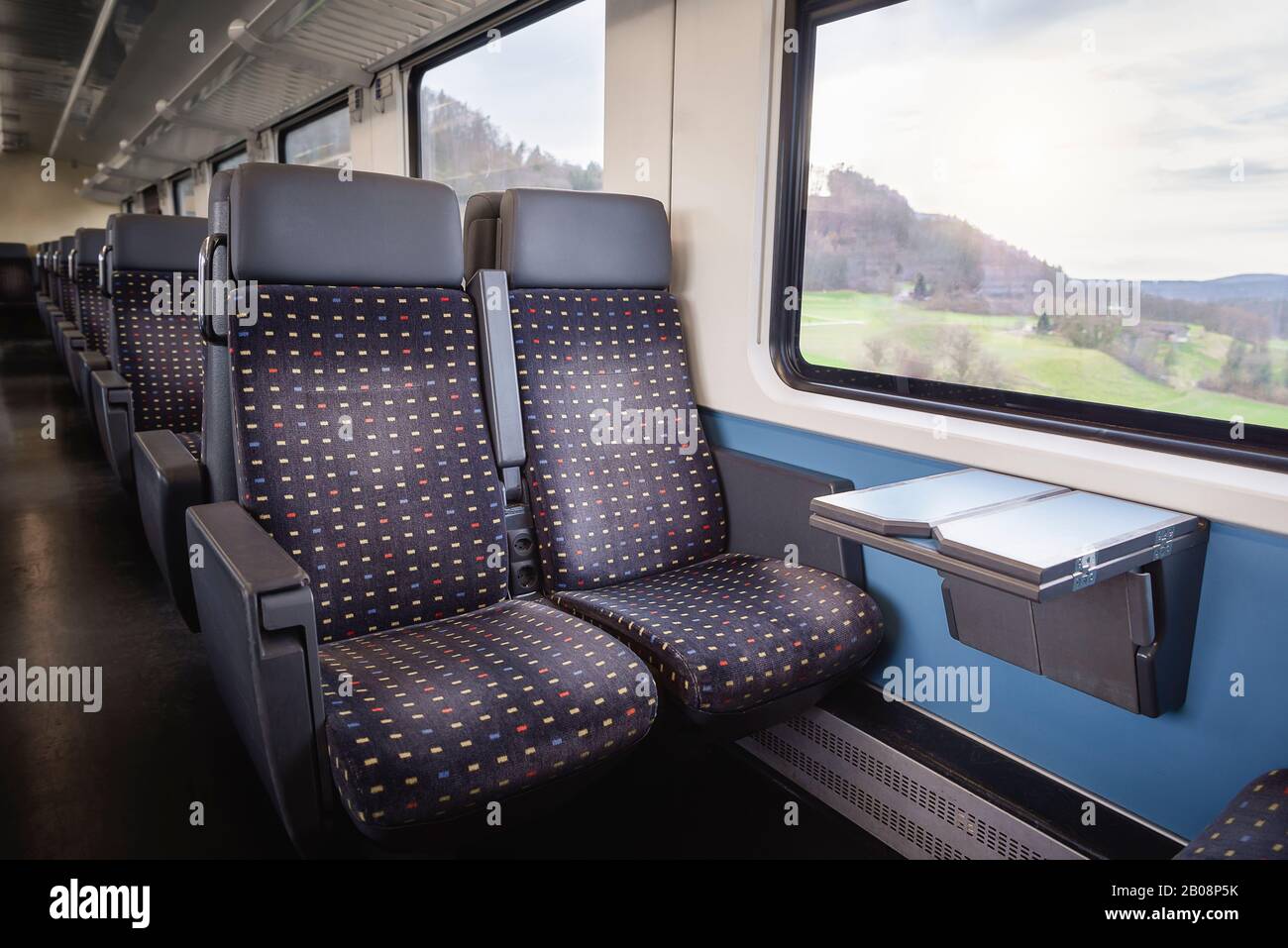 Swiss train interior with comfortable chairs, on two rows, a table and  nature view on window. Public transport context. Passenger train interior  Stock Photo - Alamy