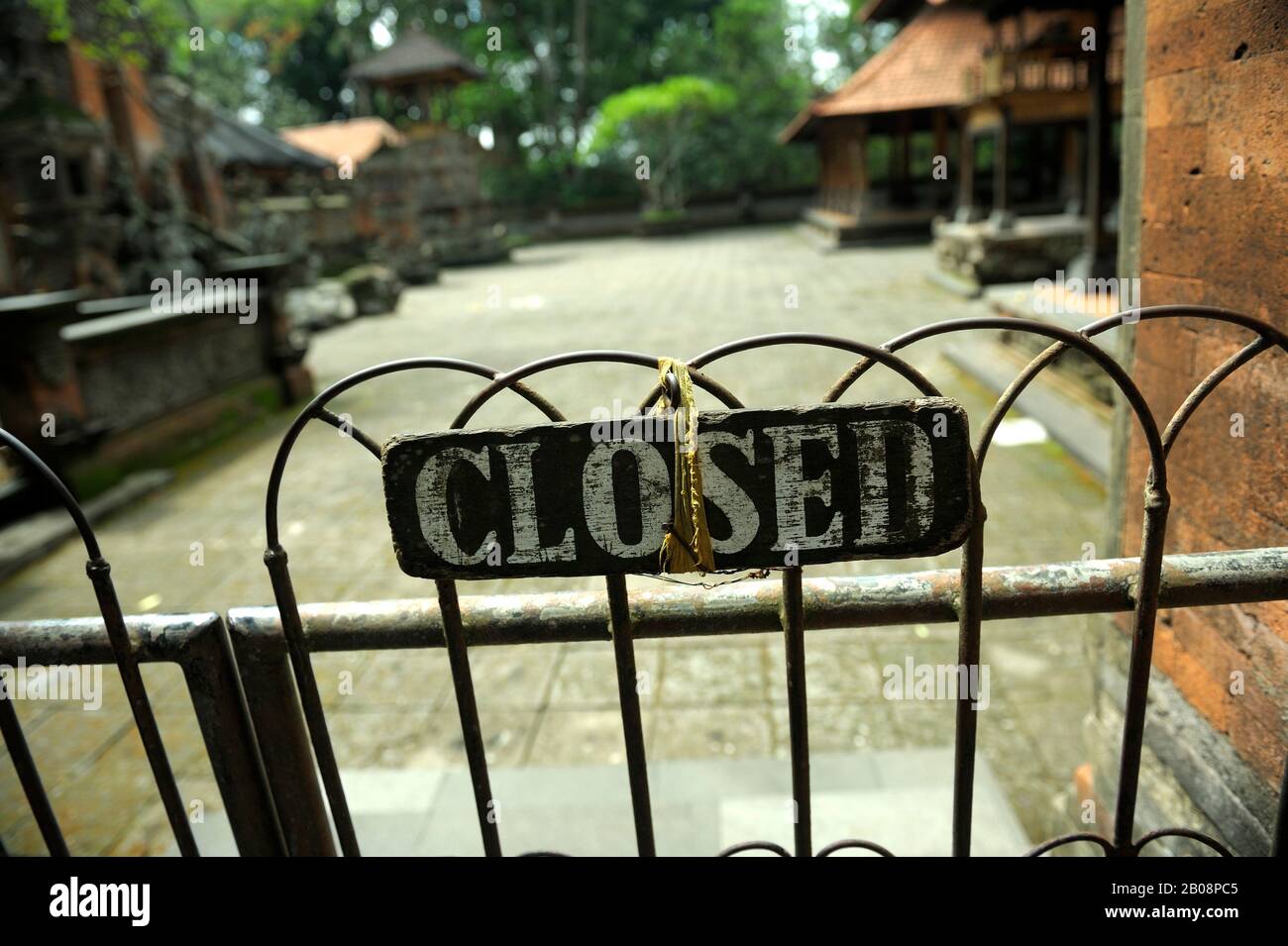 Hand-painted 'closed' sign on Balinese Hindu temple gate. Bali, Indonesia Stock Photo