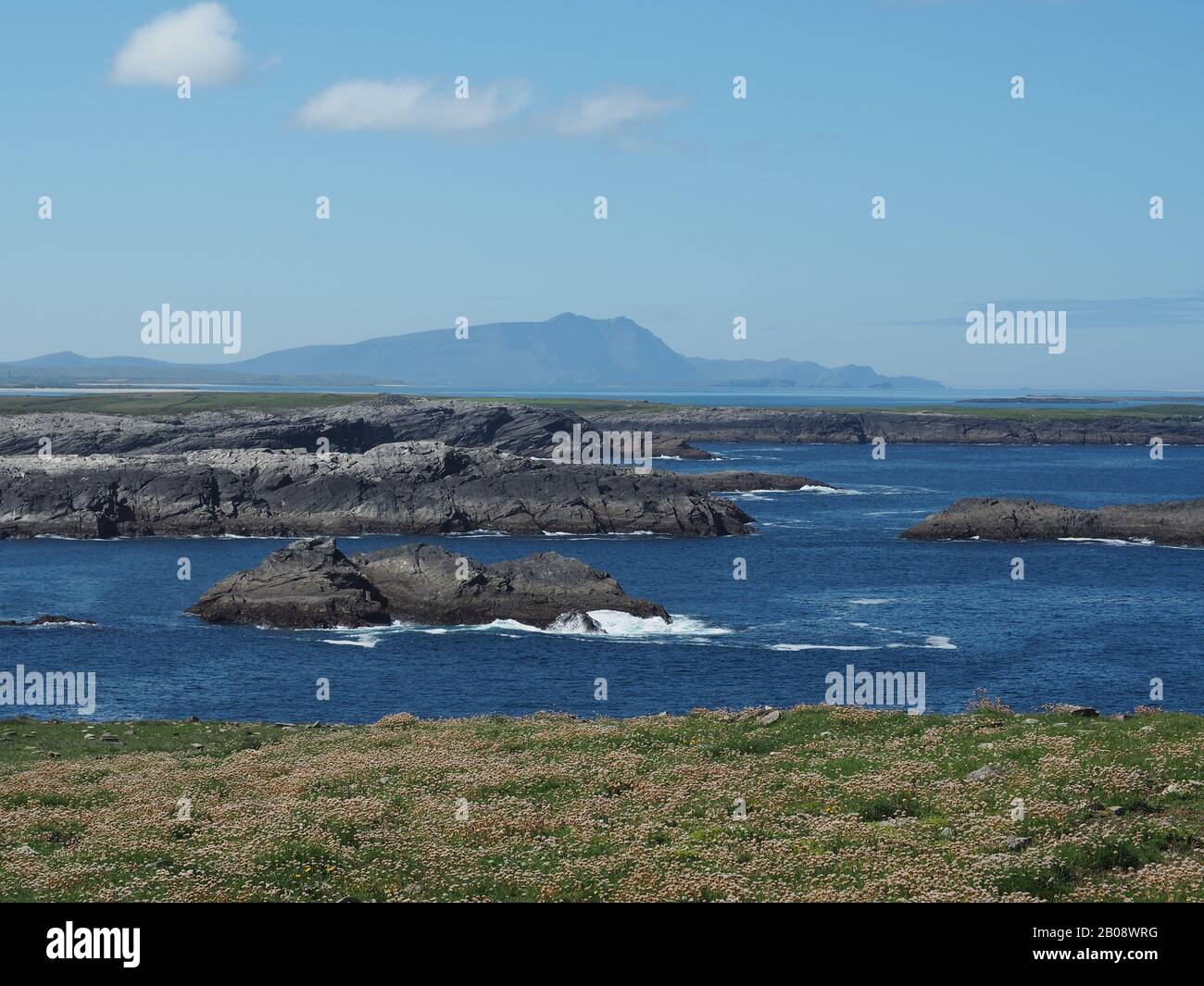 Achill Island, Erris, Co. Mayo, Ireland seen from Doonamoe Point, Gladree. The peak of Croaghaun rising from the sea. Stock Photo