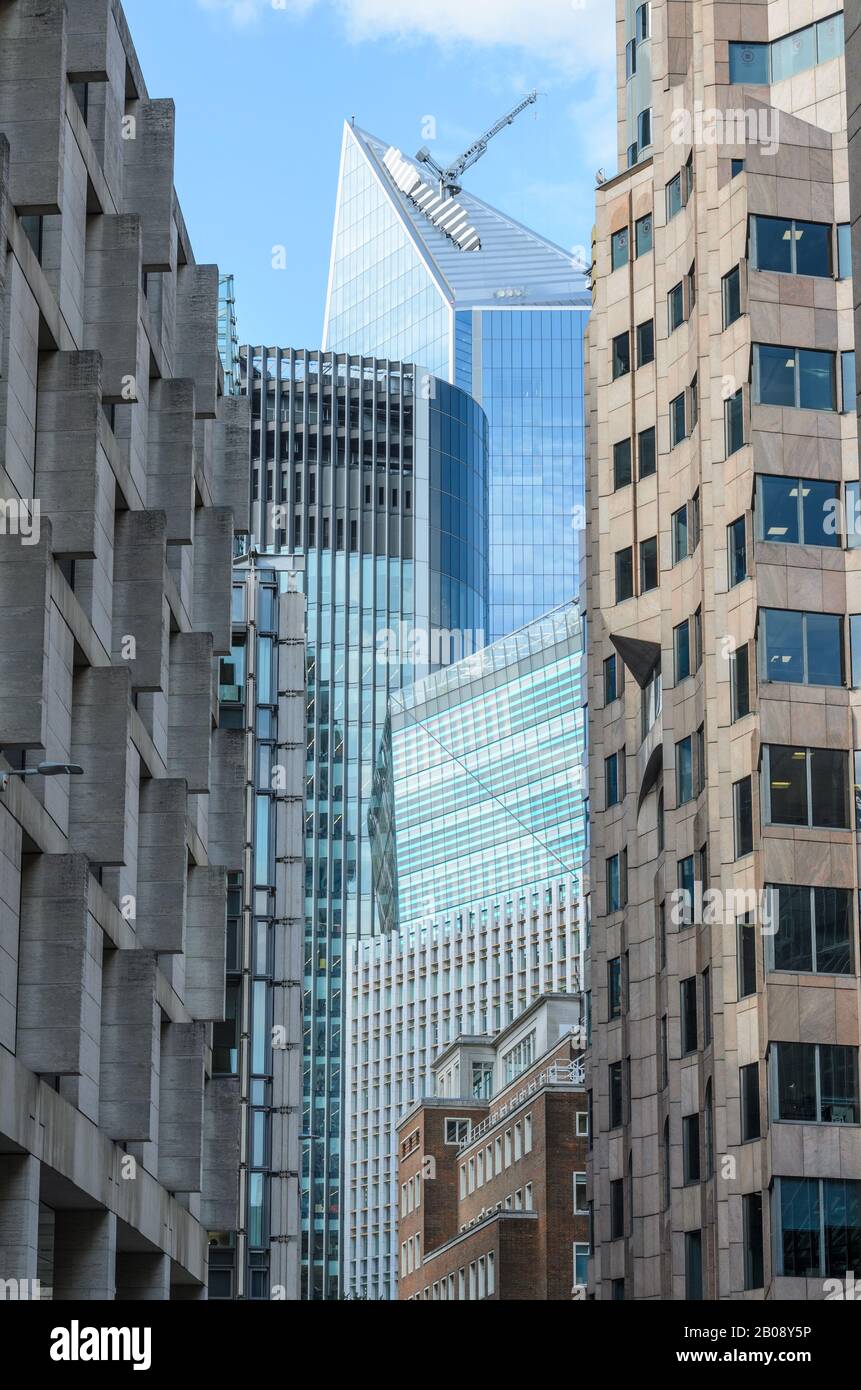 Different building designs with contrasting styles of arcitecture on Minching Lane looking towards Fenchurch Street in the City of London, England Stock Photo