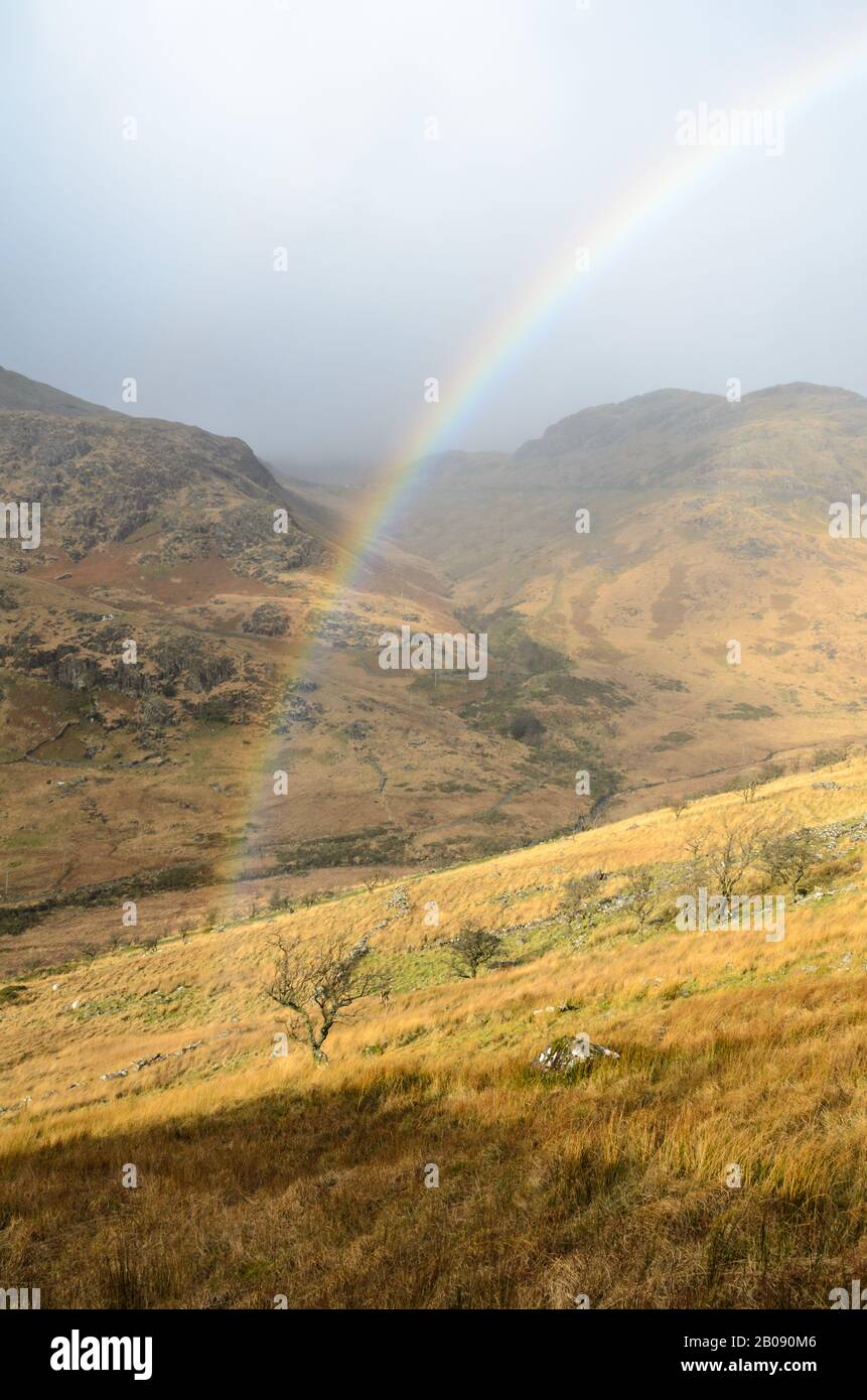 Rainbow across the hills in Snowdonia National Park, Wales, UK Stock Photo