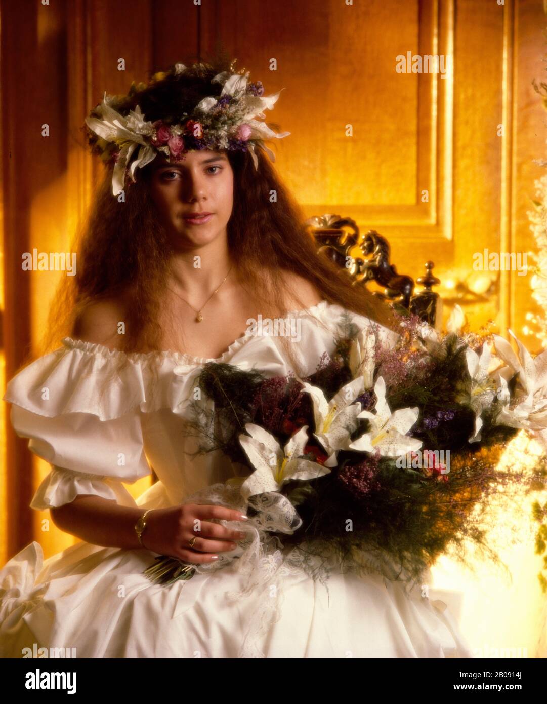 Young bride in off-shoulder dress and large bouquet Stock Photo