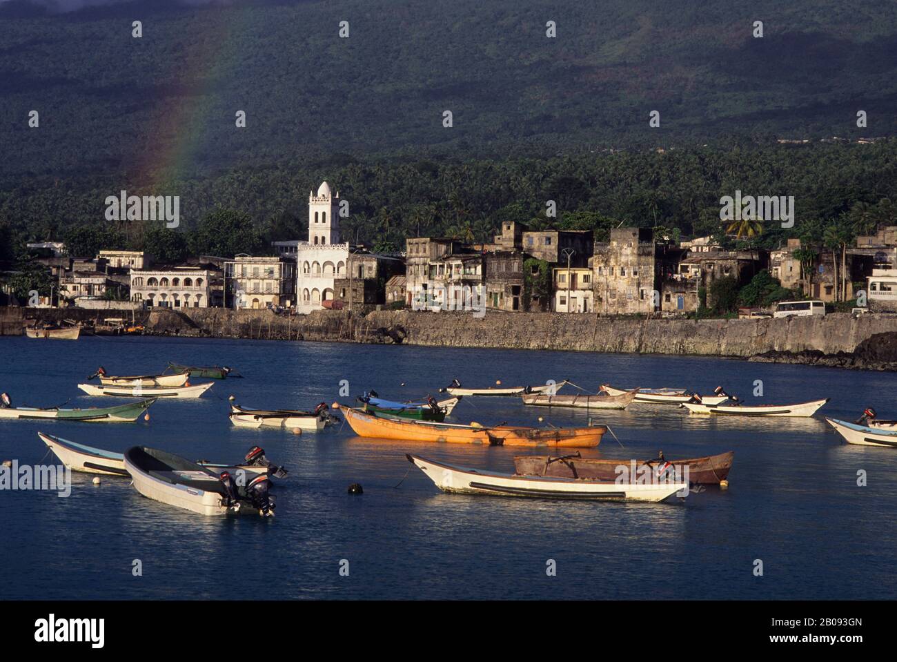 COMORO IS., GRAND COMORE, MORONI, VIEW OF TOWN WITH FISHING BOATS IN FOREGROUND, RAINBOW Stock Photo