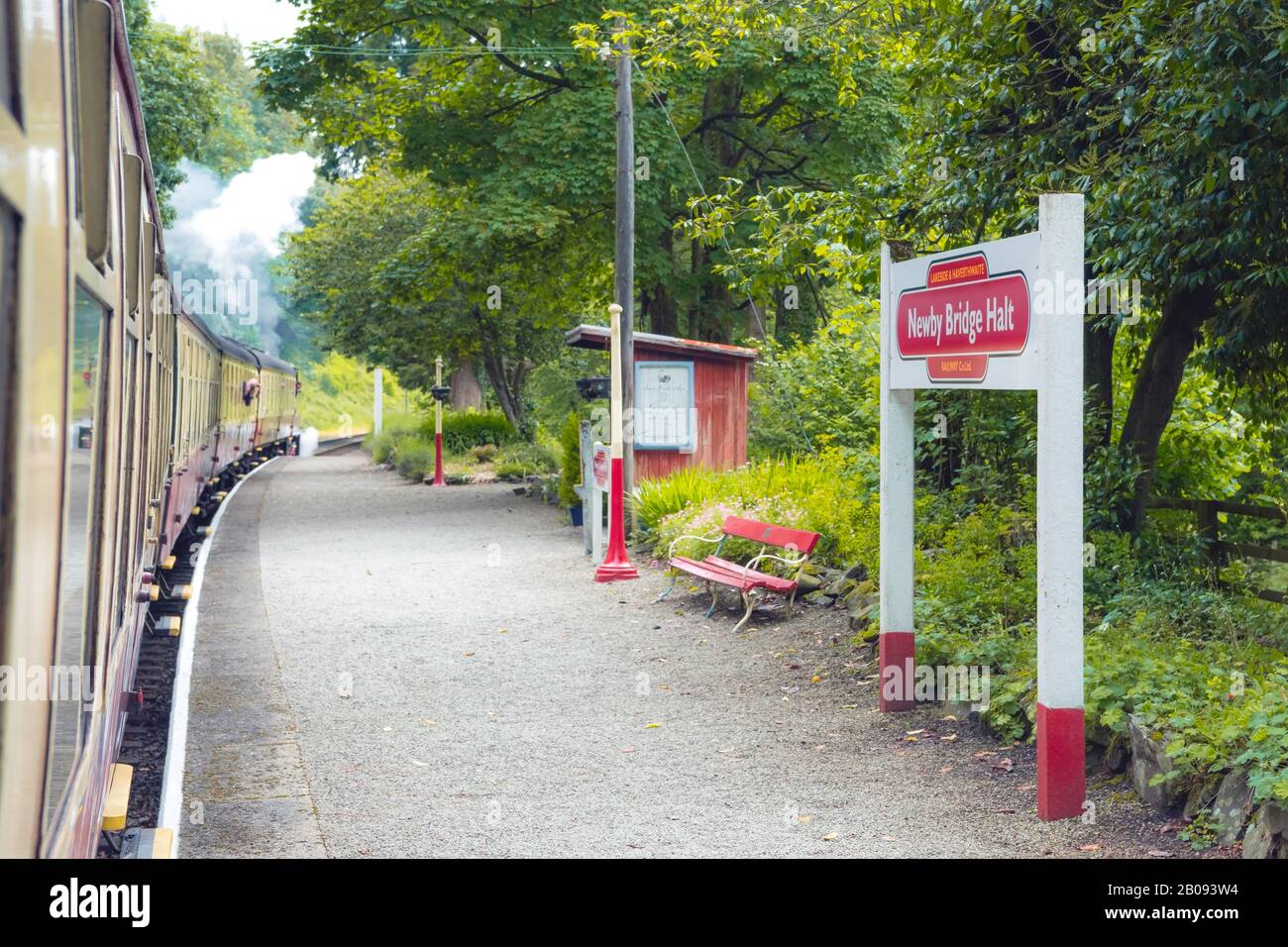 Carriages pass Newby Bridge station platform on the Lakeside and Haverthwaite railway, Lake District, UK Stock Photo